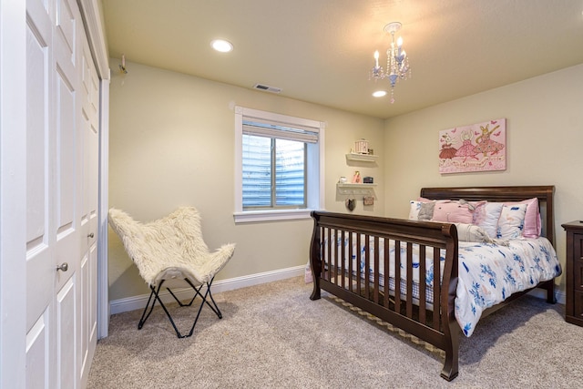 carpeted bedroom with a notable chandelier and a closet