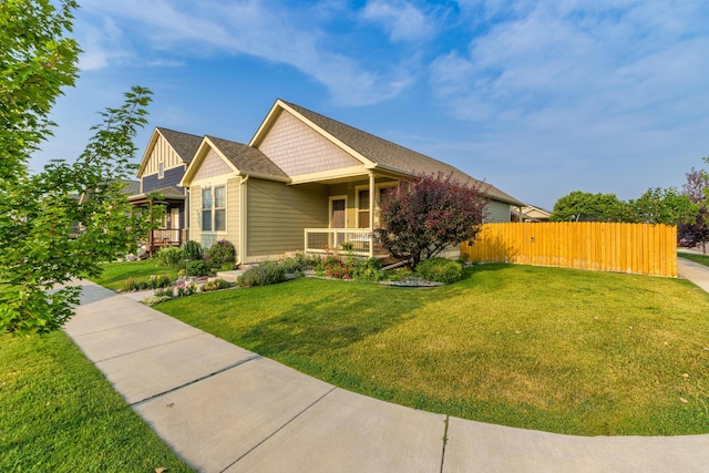 craftsman house with a porch and a front lawn