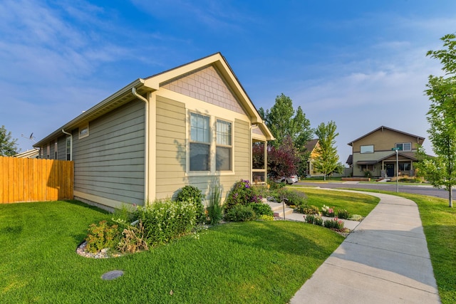 view of side of property with a lawn