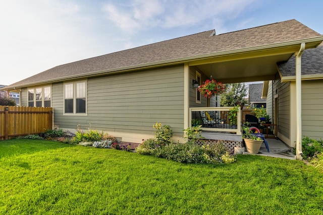 rear view of property featuring a lawn