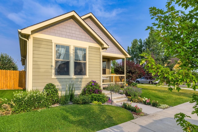 view of front of home with a porch and a front lawn