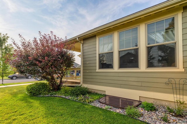 view of side of home with a yard