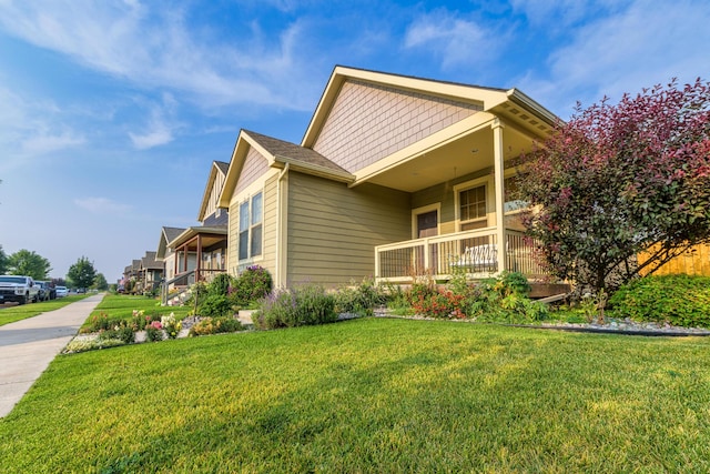 view of home's exterior featuring a yard and covered porch