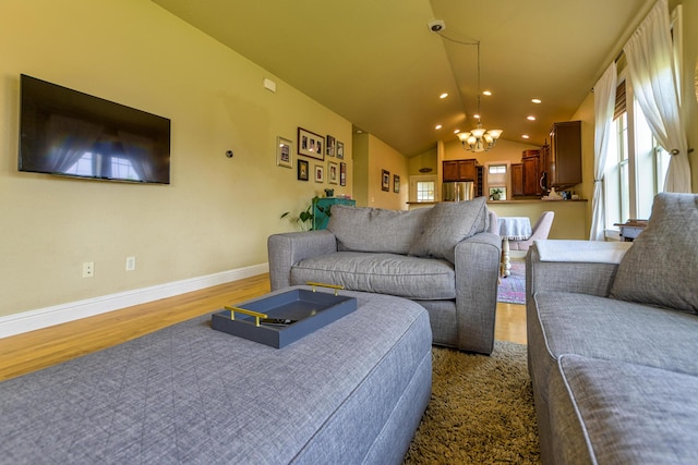 living room with dark hardwood / wood-style flooring, vaulted ceiling, and a notable chandelier