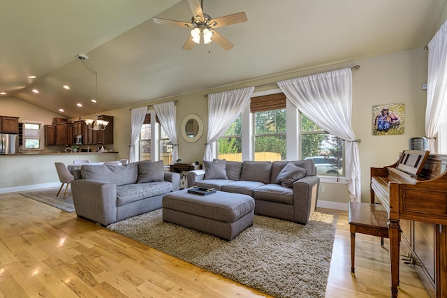 living room featuring light hardwood / wood-style flooring, ceiling fan with notable chandelier, and lofted ceiling