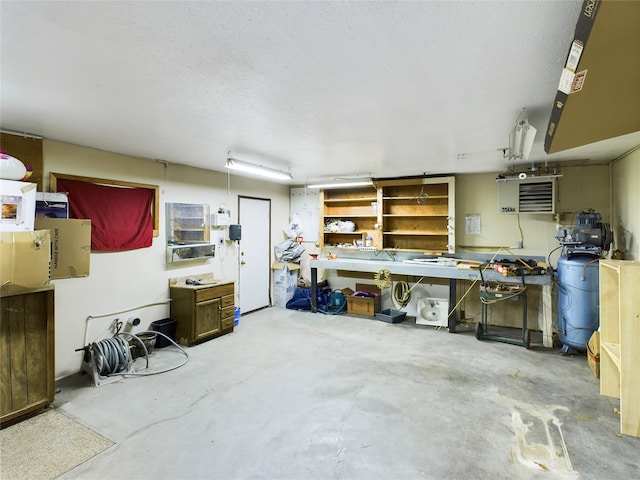 interior space with a workshop area, concrete floors, and a textured ceiling