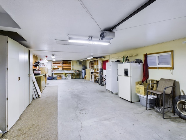 garage with a workshop area, a garage door opener, and white refrigerator