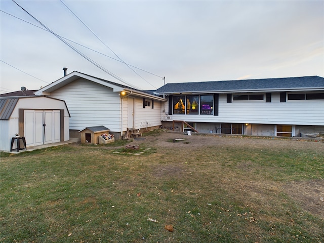 back of property featuring a lawn and a shed