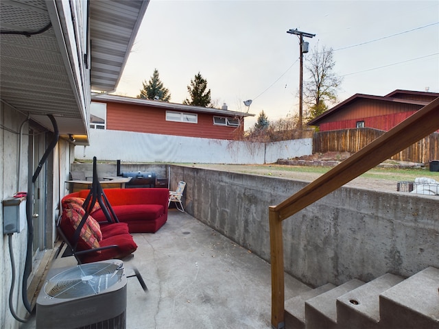 patio terrace at dusk featuring central AC