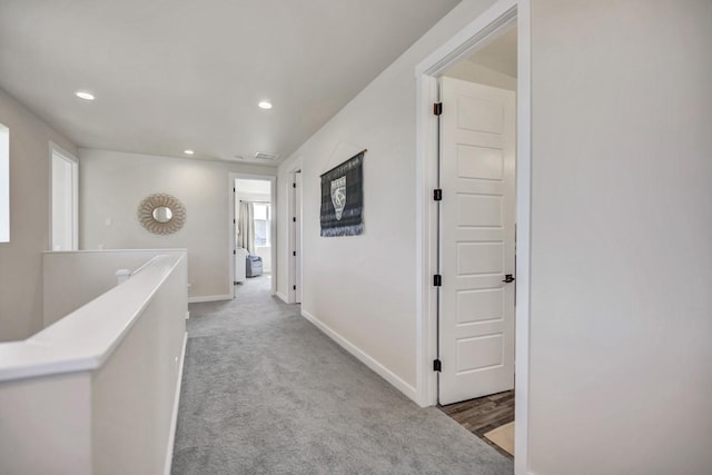 hall featuring light colored carpet