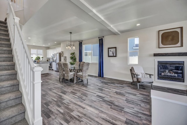 dining room with hardwood / wood-style flooring and a notable chandelier