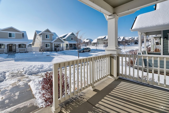 view of snow covered back of property