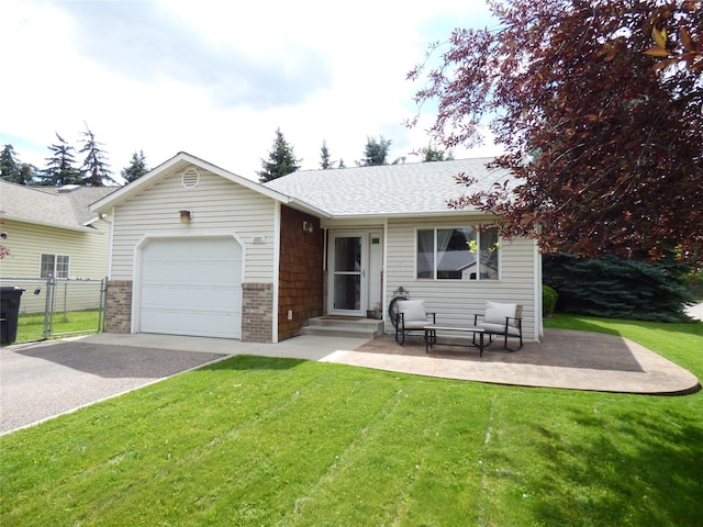 view of front of house featuring a garage, a patio, and a front lawn