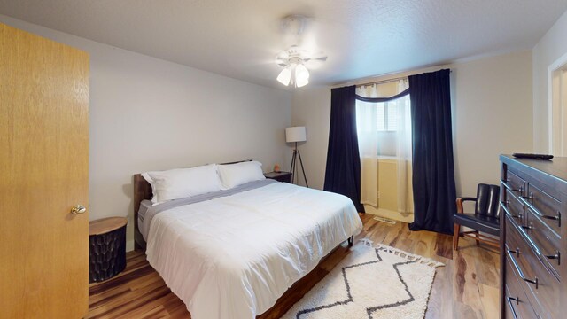 bedroom with wood-type flooring and ceiling fan