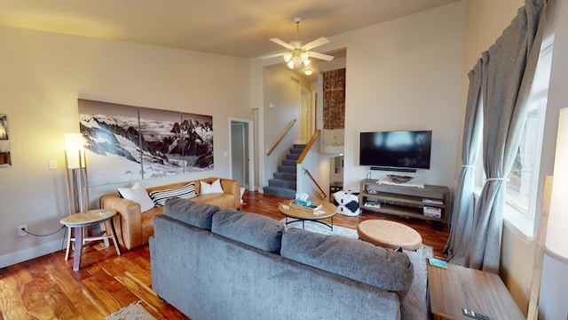 living room featuring ceiling fan and wood-type flooring