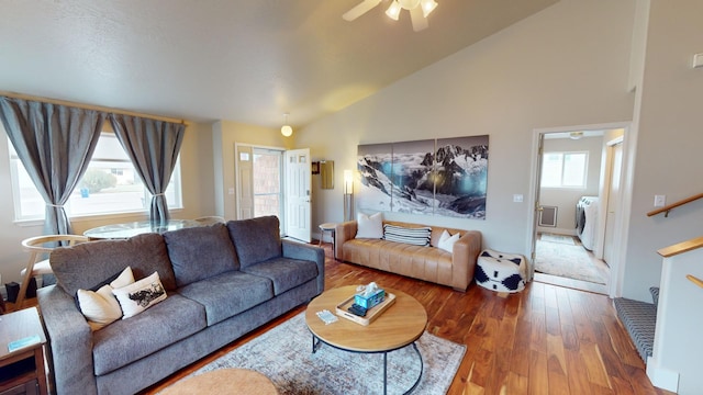 living room featuring separate washer and dryer, ceiling fan, hardwood / wood-style floors, and high vaulted ceiling