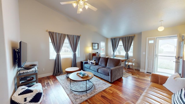 living room featuring ceiling fan, wood-type flooring, and lofted ceiling