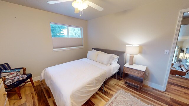 bedroom featuring ceiling fan and hardwood / wood-style floors