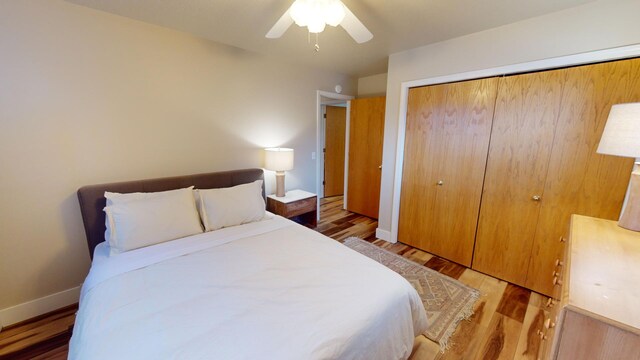 bedroom featuring wood-type flooring, a closet, and ceiling fan