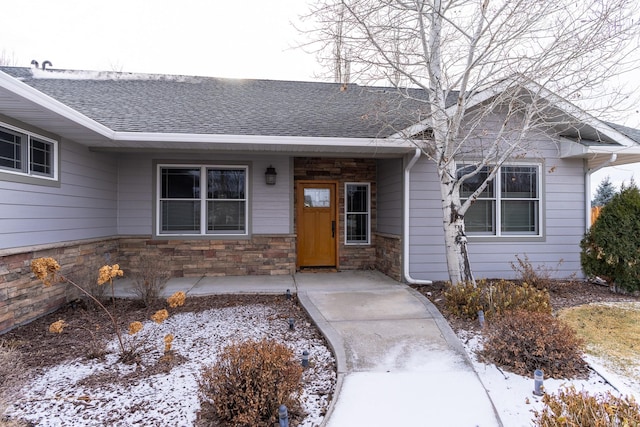 view of snow covered property entrance