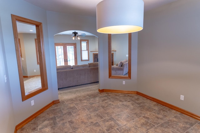 empty room featuring french doors and ceiling fan