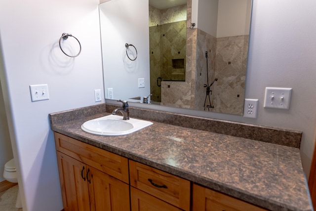 bathroom with vanity, toilet, and walk in shower