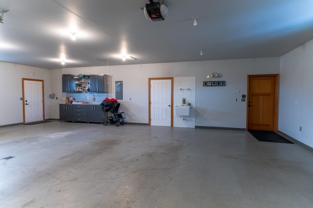 garage featuring electric panel and a garage door opener