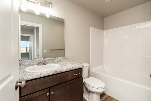 full bathroom with wood-type flooring, vanity, toilet, and  shower combination