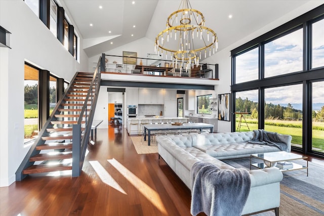 living room featuring a chandelier, high vaulted ceiling, and a wealth of natural light