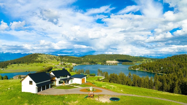 drone / aerial view featuring a water and mountain view