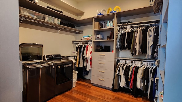 spacious closet featuring independent washer and dryer and dark wood-type flooring