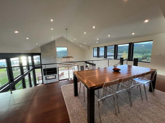 dining area featuring high vaulted ceiling and dark wood-type flooring