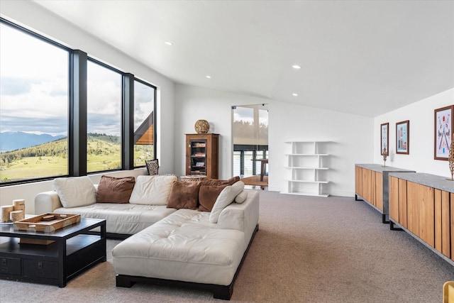 living room featuring light carpet, a mountain view, and vaulted ceiling