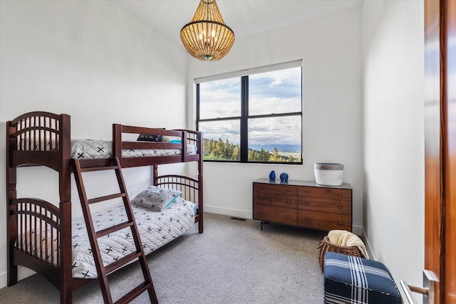 carpeted bedroom featuring an inviting chandelier