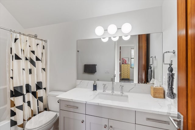 bathroom featuring vanity, lofted ceiling, and toilet