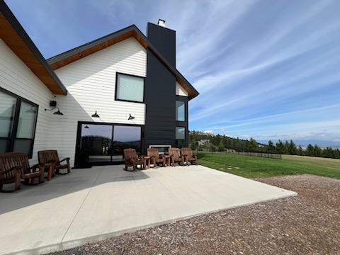 rear view of property featuring a patio area