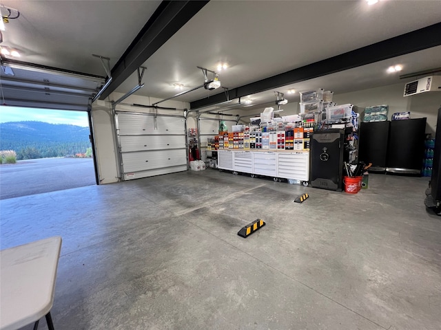 garage with a mountain view and a garage door opener