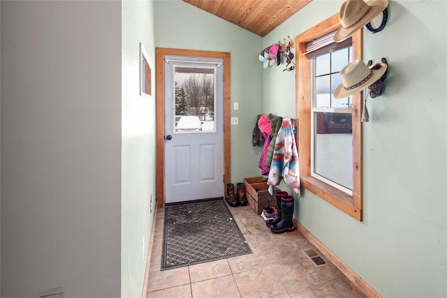 doorway with light tile patterned floors, lofted ceiling, and wood ceiling