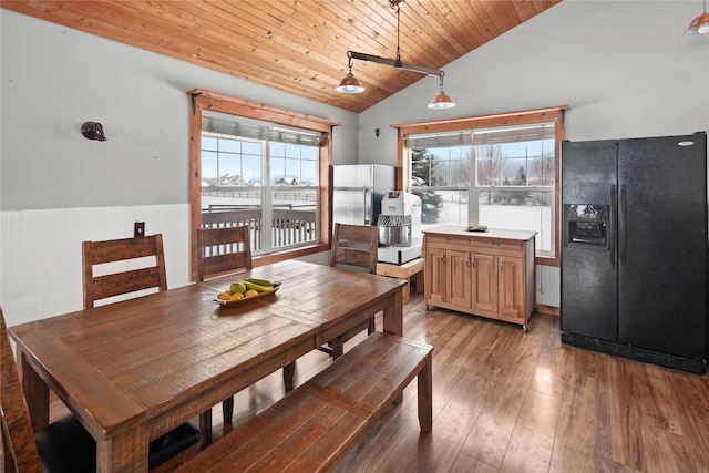 dining area with hardwood / wood-style flooring, vaulted ceiling, and wooden ceiling