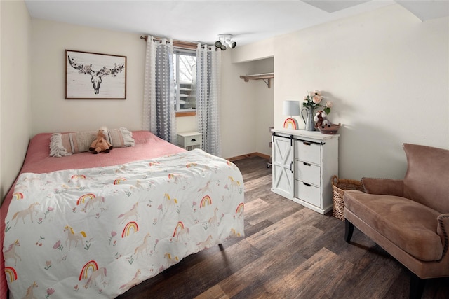 bedroom with a closet and dark hardwood / wood-style floors