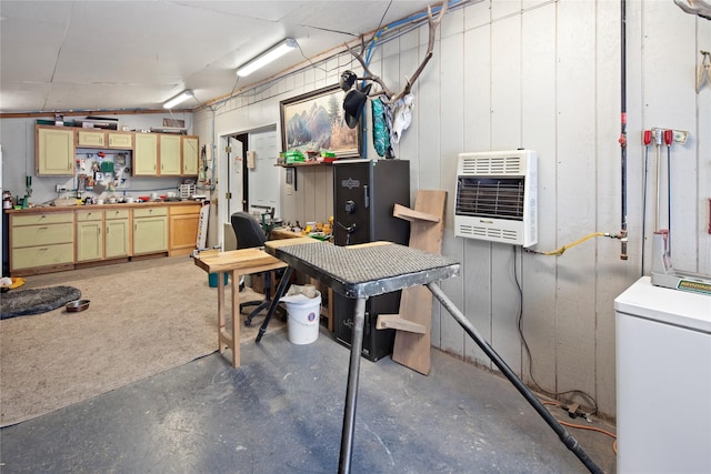 basement featuring a workshop area and heating unit