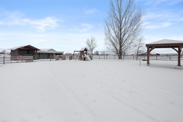 yard layered in snow with a rural view