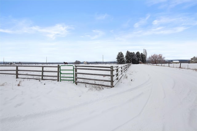 snowy yard with a rural view