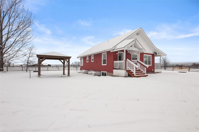 view of snow covered exterior with a gazebo