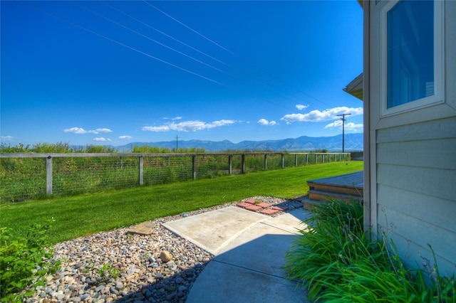 view of yard featuring a mountain view and a patio