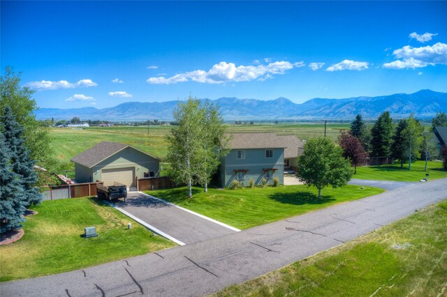 view of front of property featuring a garage and a front lawn