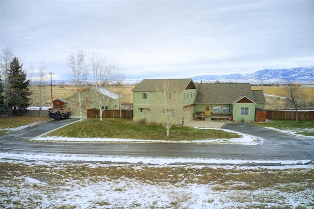 view of front of home featuring a mountain view and a lawn