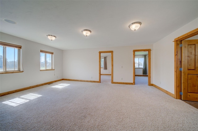 carpeted spare room with a healthy amount of sunlight