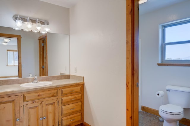 bathroom with tile patterned floors, vanity, and toilet