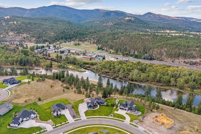 birds eye view of property with a water and mountain view